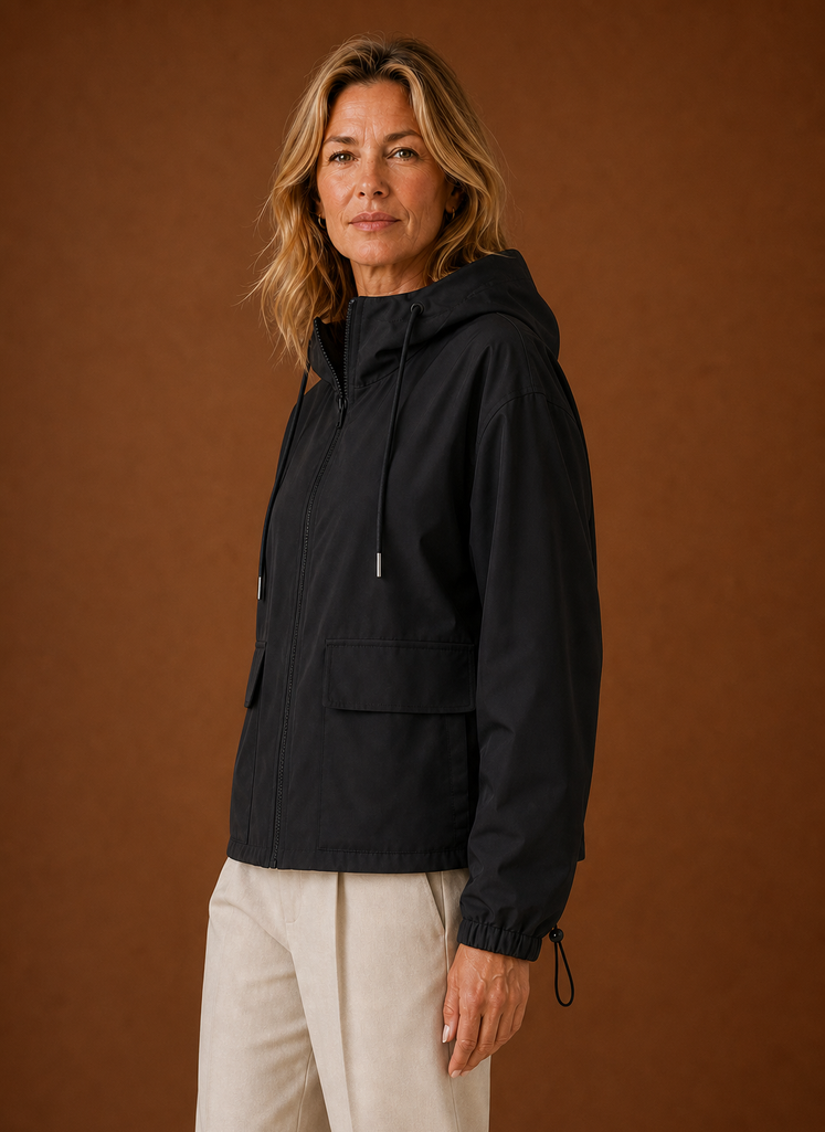 Lightweight hooded windbreaker jacket for women, perfect for versatile outdoor wear, featuring a stylish design and breathable fabric ideal for various weather conditions. 1
