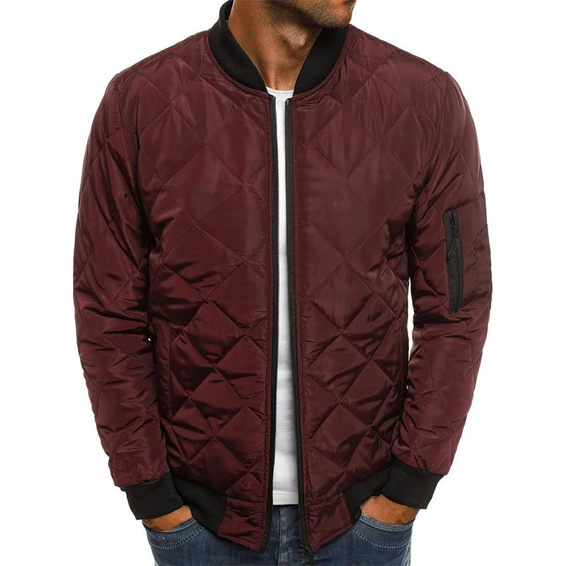 Men's quilted bomber jacket featuring ribbed trim and a zip pocket, perfect for stylish warmth and functionality. 1