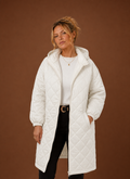 Women's long quilted hooded winter coat featuring a relaxed fit, designed for warmth and comfort during cold weather. 0