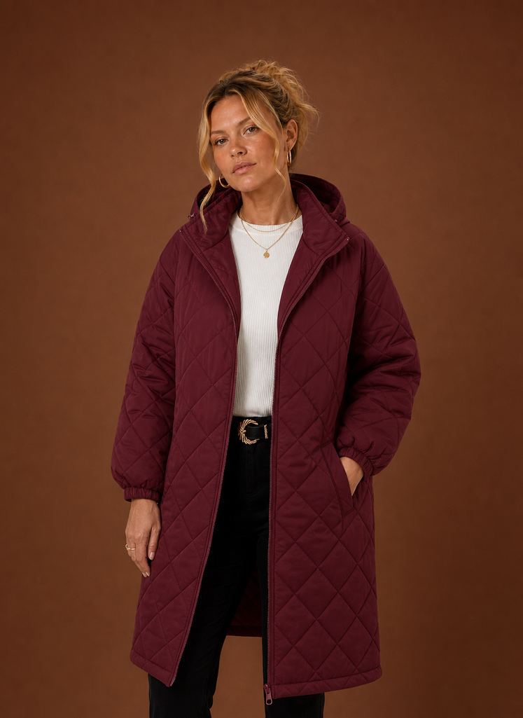 Women's long quilted hooded winter coat featuring a relaxed fit, designed for warmth and comfort during cold weather. 1