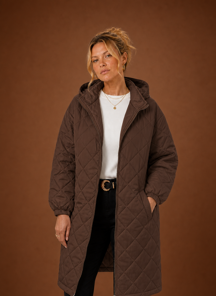 Women's long quilted hooded winter coat featuring a relaxed fit, designed for warmth and comfort during cold weather. 2