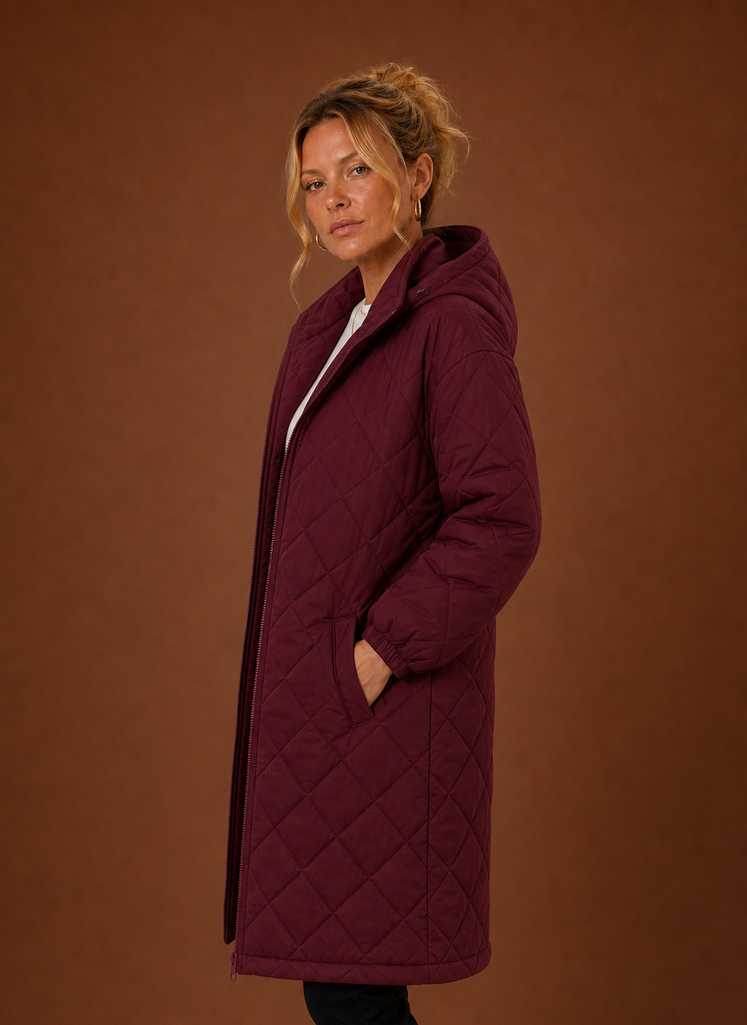 Women's long quilted hooded winter coat featuring a relaxed fit, designed for warmth and comfort during cold weather. 6
