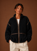 Women's Sherpa zip-up fleece jacket featuring cozy patch pockets, perfect for layering in cold weather. 0