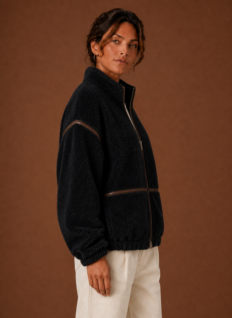 Women's Sherpa zip-up fleece jacket featuring cozy patch pockets, perfect for layering in cold weather. 3